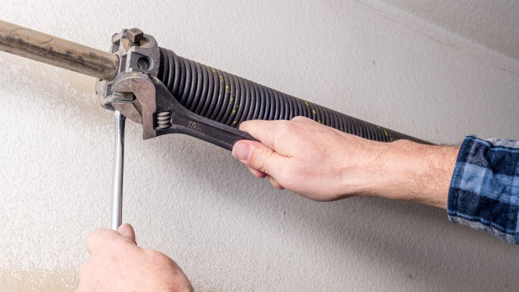 A man repairing a torsion spring above a garage door in Wisconsin