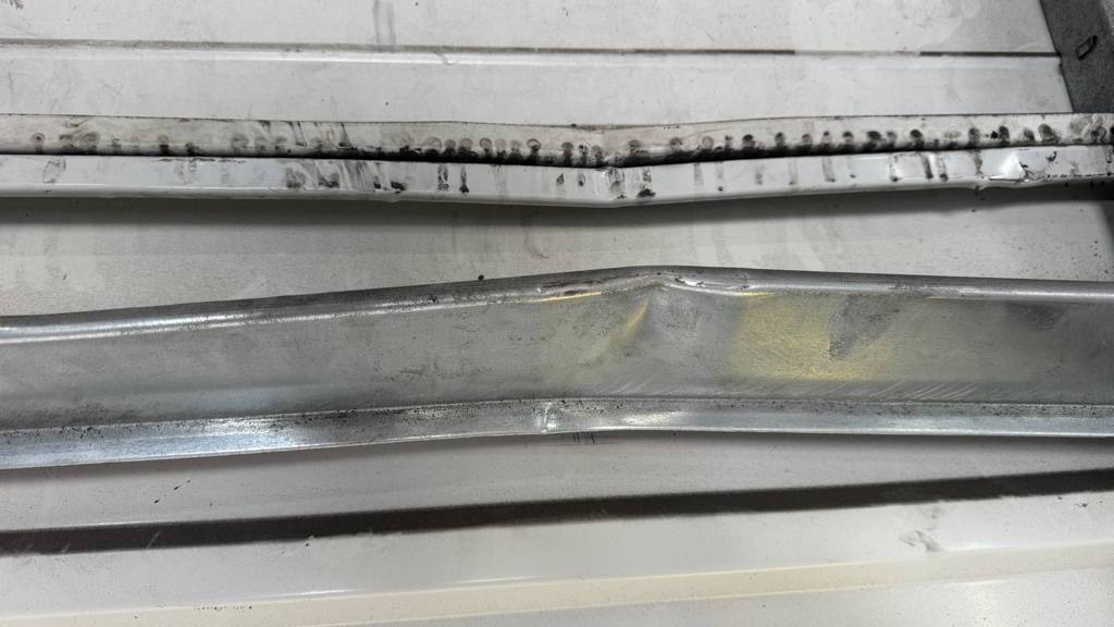  Garage panel repair highlighting multiple dents in overhead garage door panels.