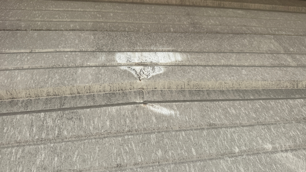 Garage panel repair showing dents across garage door panels.