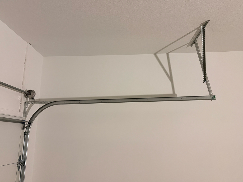 Close-up of a garage door track repair on a residential overhead door.