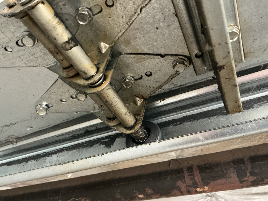 Garage door track repair with bent track requiring professional adjustment and replacement
