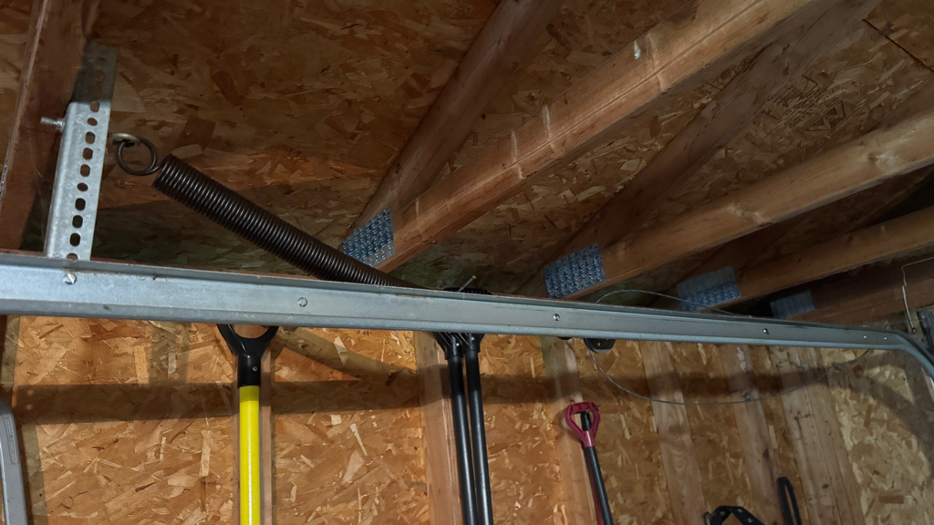 Garage door track repair for a bent vertical track inside a residential garage.
