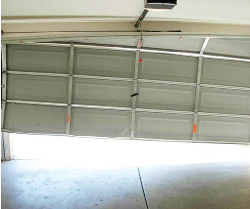 Garage door off-track repair showing a misaligned door