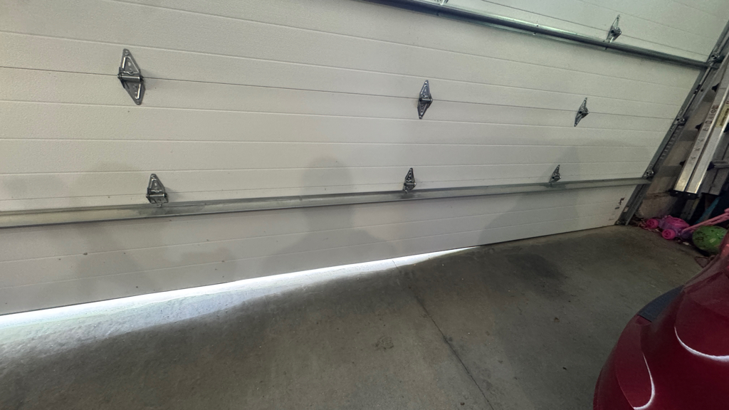 Garage door off-track repair with damaged door alignment